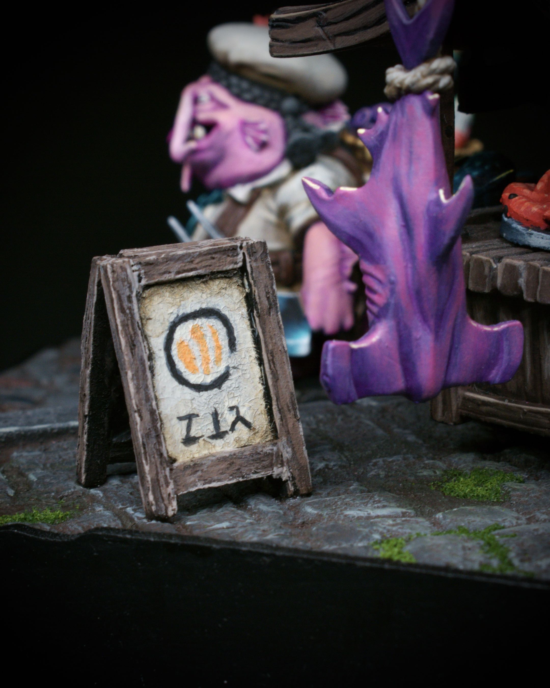 Close view of the miniature A-frame sign beside the sushi cart.